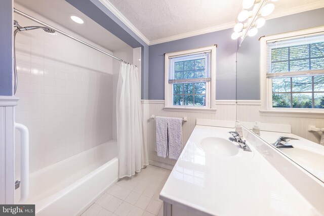full bath featuring vanity, ornamental molding, shower / bath combination with curtain, tile patterned floors, and a wainscoted wall