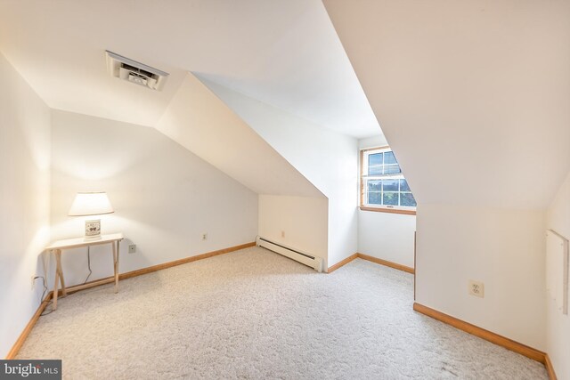 additional living space featuring carpet flooring, visible vents, baseboard heating, and vaulted ceiling