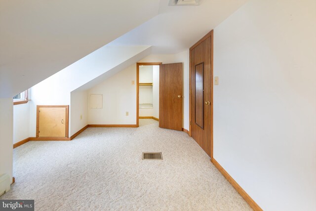 bonus room with carpet floors, baseboards, visible vents, and vaulted ceiling