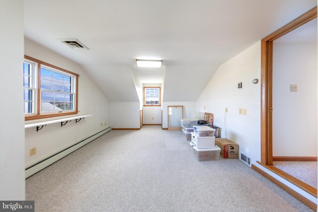 bonus room featuring a healthy amount of sunlight, carpet floors, a baseboard heating unit, and visible vents