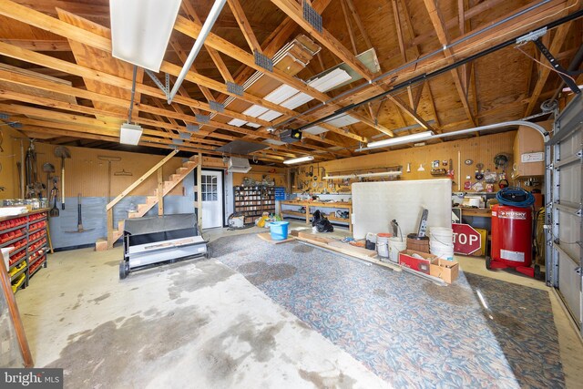 garage with a workshop area and a garage door opener