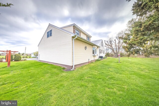 view of side of home featuring a yard