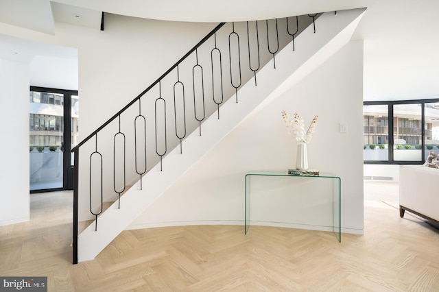 staircase featuring light parquet floors