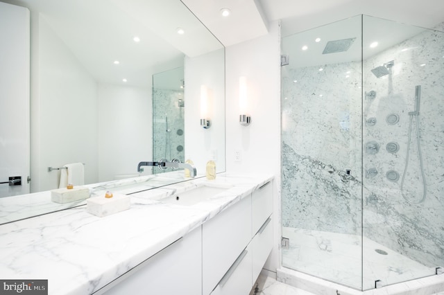 bathroom featuring vanity with extensive cabinet space, a shower with shower door, and tile floors