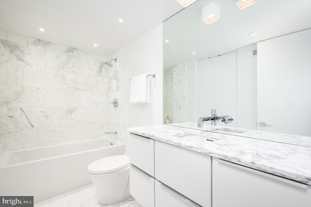 full bathroom featuring tile flooring, toilet, vanity, and tiled shower / bath