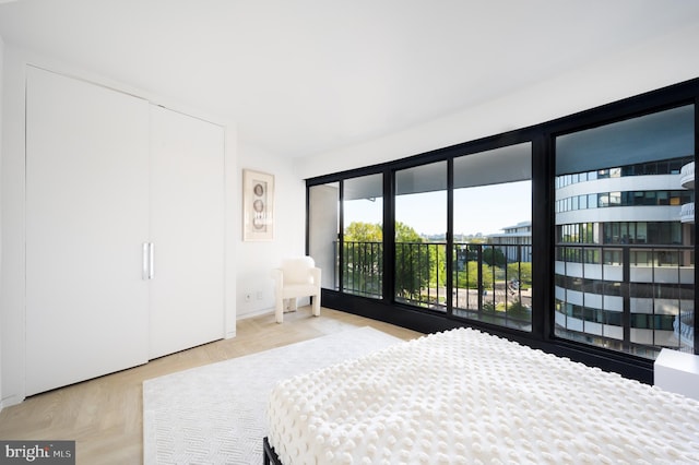 bedroom with light parquet flooring and access to outside