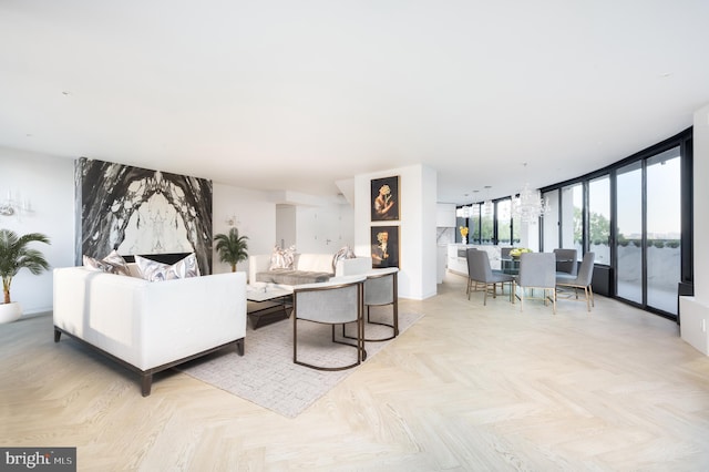 living room with light parquet flooring and a wall of windows