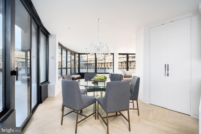 dining space featuring an inviting chandelier and light parquet flooring