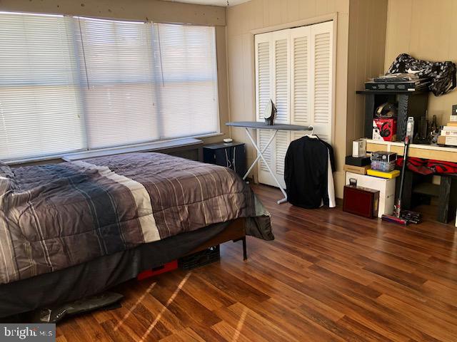 bedroom with dark wood-type flooring