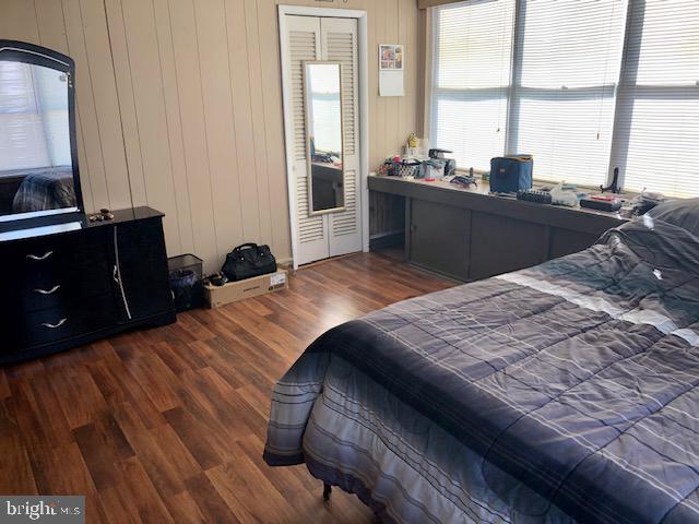 bedroom with dark hardwood / wood-style flooring