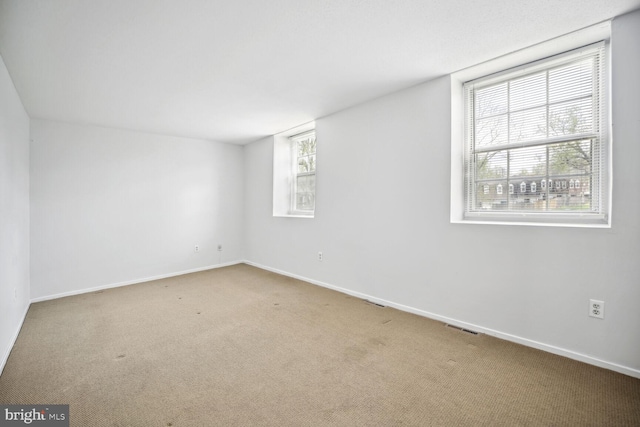 carpeted empty room featuring a healthy amount of sunlight