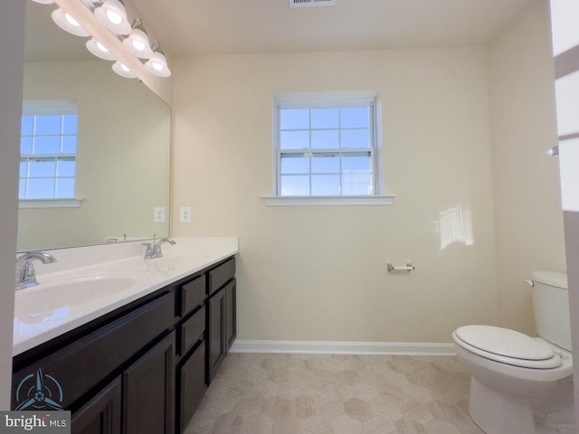 bathroom with dual bowl vanity, toilet, and tile flooring