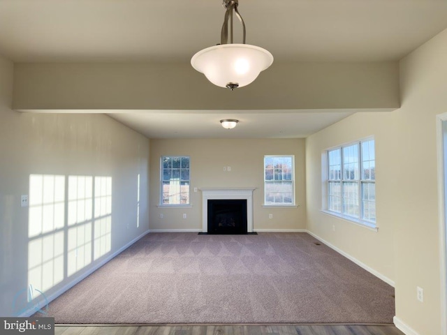 unfurnished living room featuring light carpet