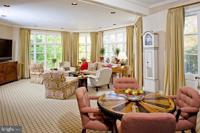 carpeted living room featuring a wealth of natural light and crown molding