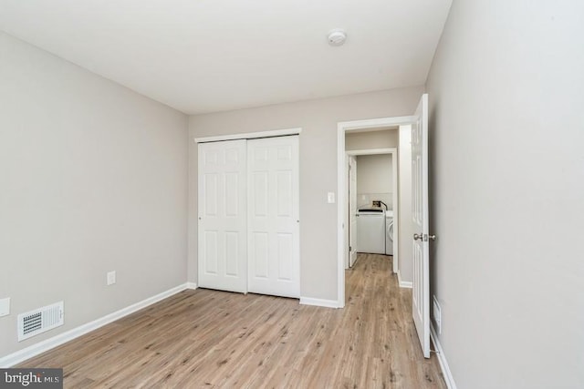 unfurnished bedroom featuring a closet and light hardwood / wood-style flooring