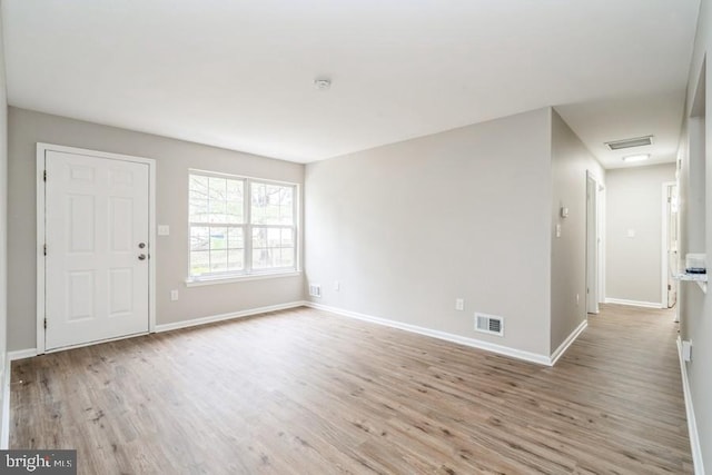 spare room with light hardwood / wood-style floors