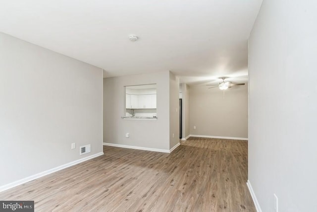 spare room featuring ceiling fan and light hardwood / wood-style flooring