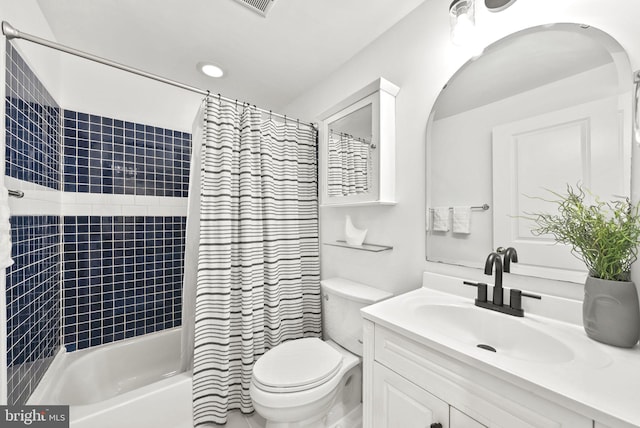 full bathroom featuring toilet, shower / tub combo with curtain, and large vanity