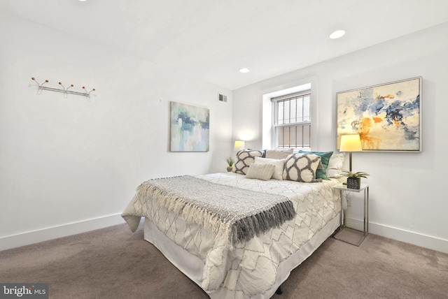 bedroom with dark colored carpet