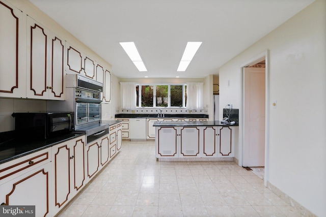 kitchen with sink, stainless steel appliances, white cabinets, and light tile floors