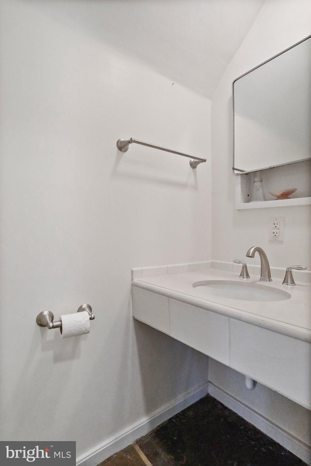 bathroom with vanity and lofted ceiling