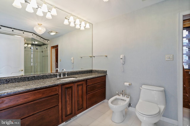 bathroom featuring large vanity, tile floors, toilet, and a bidet