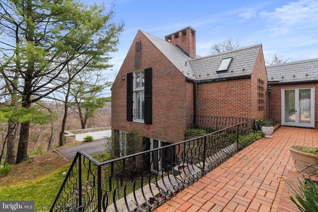 view of side of home featuring french doors