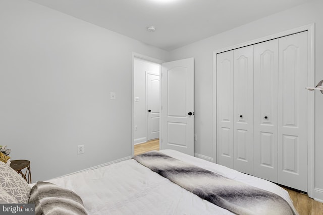 bedroom featuring light hardwood / wood-style floors and a closet