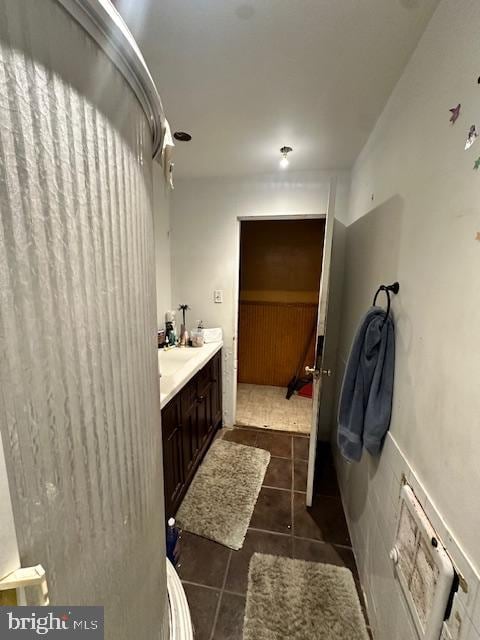 bathroom featuring tile flooring and vanity