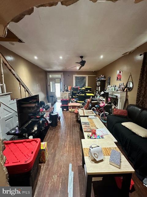 interior space with hardwood / wood-style floors and ceiling fan