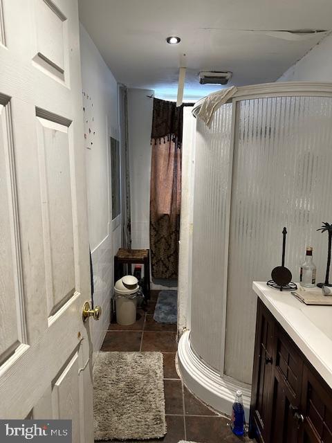 bathroom featuring vanity, tile floors, and toilet