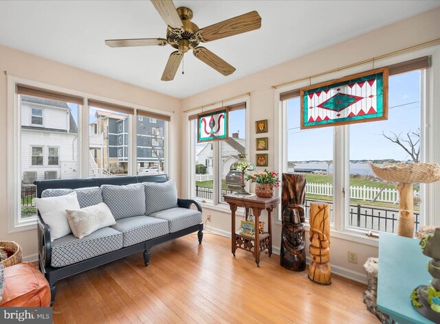 sunroom / solarium with plenty of natural light and ceiling fan