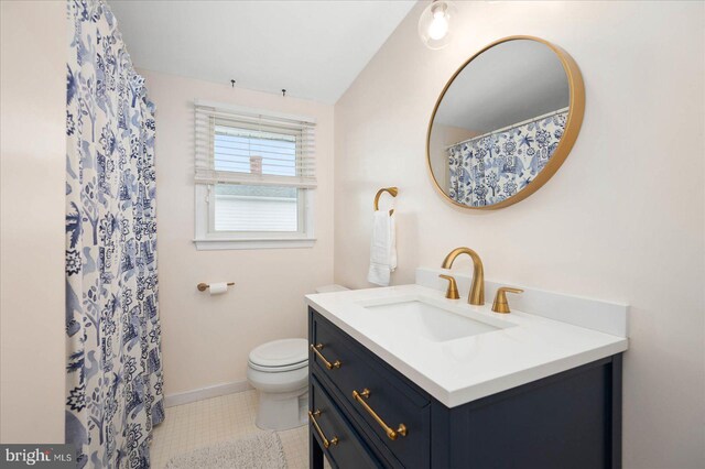 bathroom with toilet, tile floors, and oversized vanity