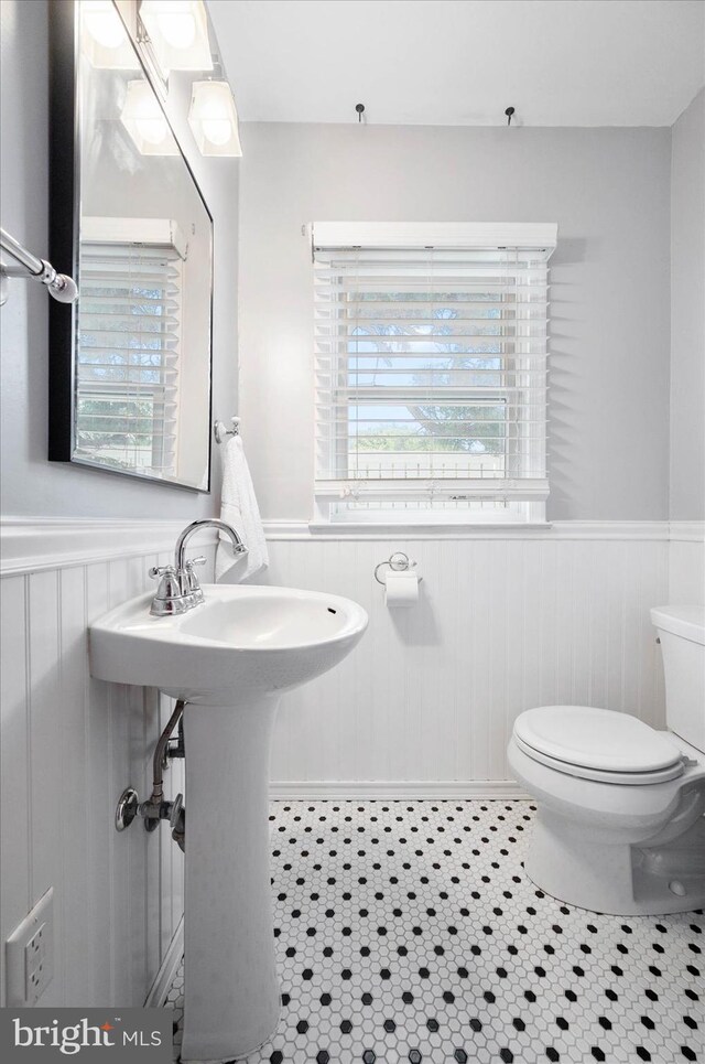 bathroom with plenty of natural light, tile flooring, and toilet