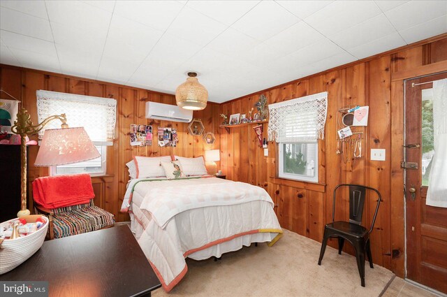 bedroom with wooden walls, a wall mounted AC, and multiple windows