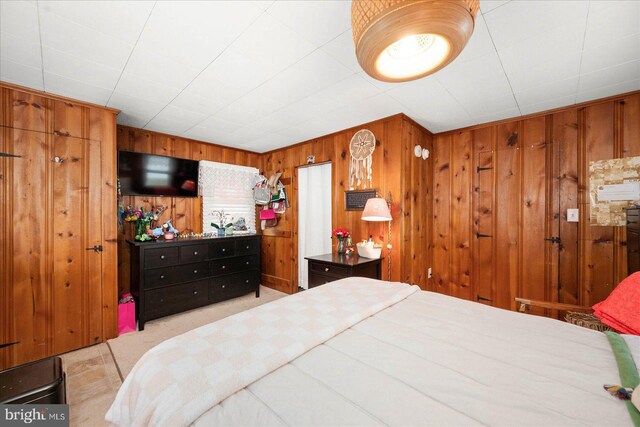 bedroom with wood walls