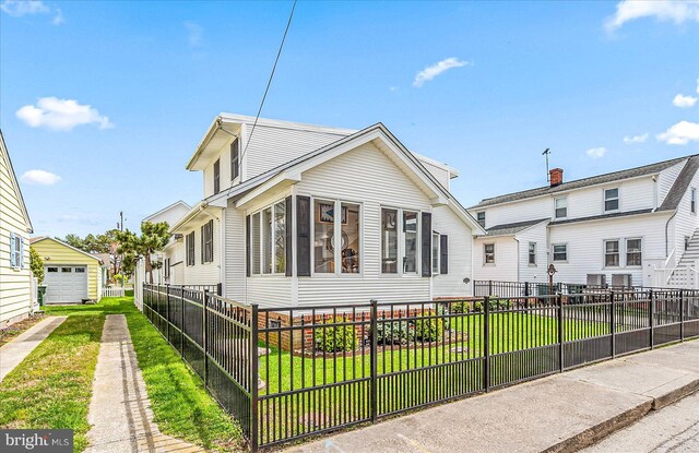 view of front of home with a front lawn and a garage