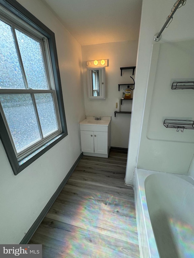 bathroom featuring shower / bath combination, vanity, and hardwood / wood-style flooring