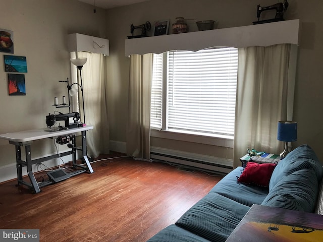 living room with dark hardwood / wood-style floors, a wealth of natural light, and a baseboard radiator