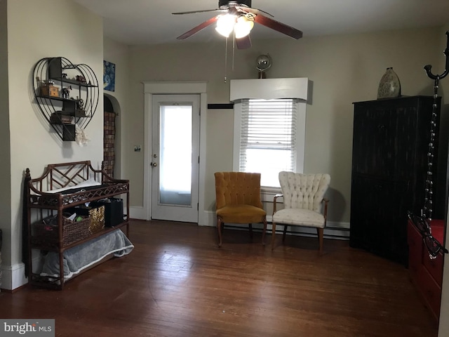 living area with wood-type flooring and ceiling fan