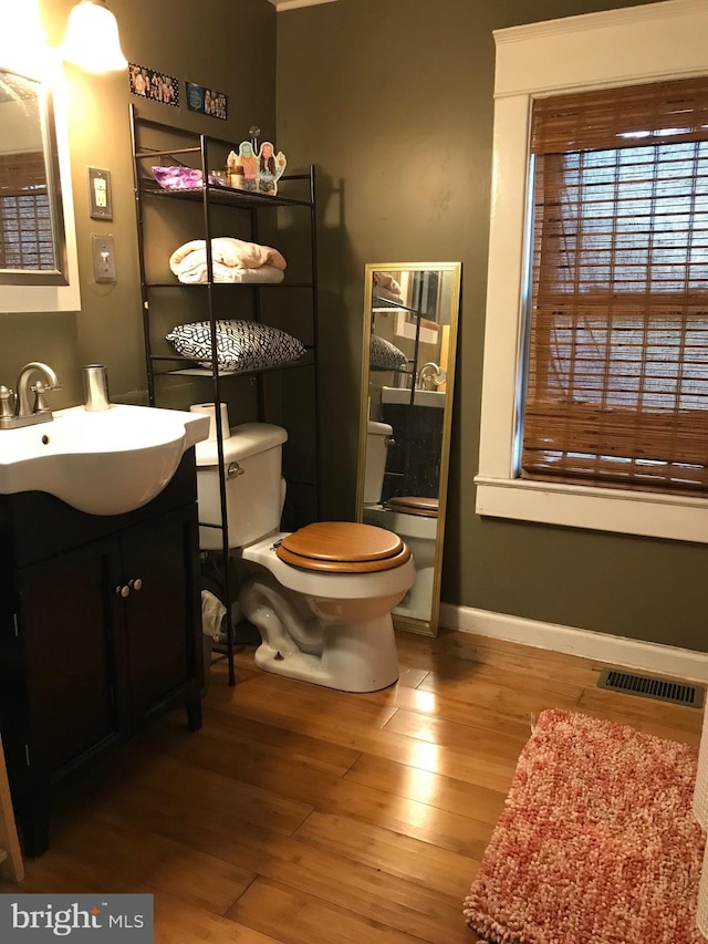 bathroom featuring hardwood / wood-style floors, vanity, and toilet