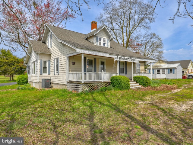 view of front facade with central AC unit, a front lawn, and a porch