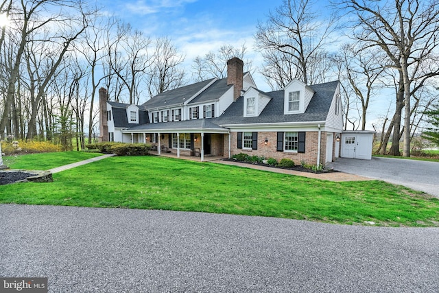 view of front of home with a front lawn and a garage