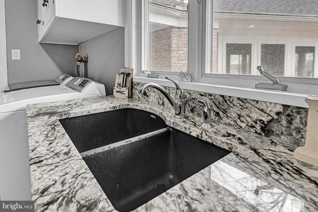 interior details with sink and washing machine and dryer