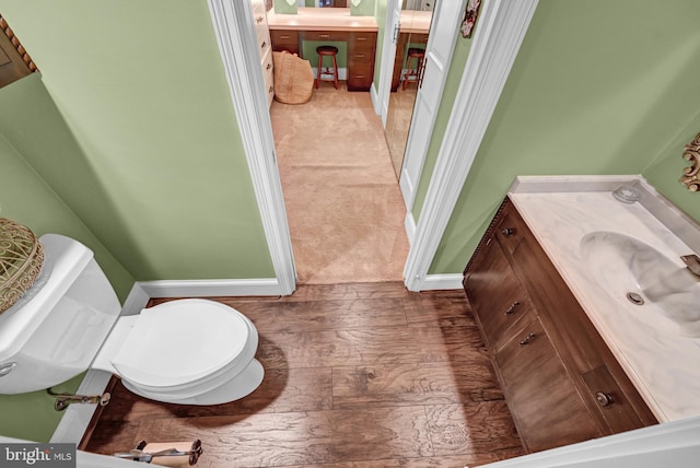 bathroom featuring vanity, toilet, and wood-type flooring