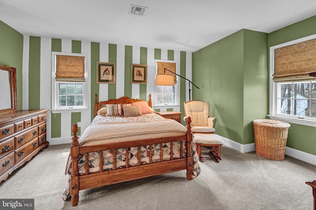 bedroom with multiple windows and carpet floors