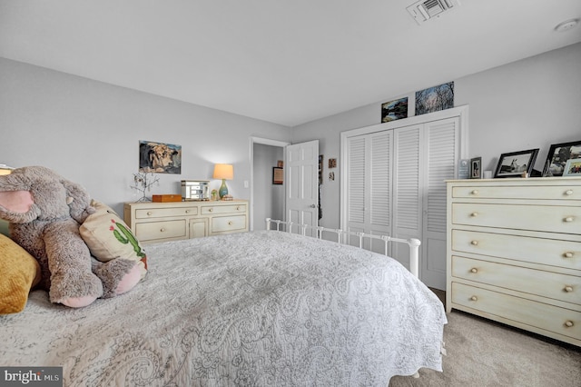 bedroom featuring light colored carpet and a closet