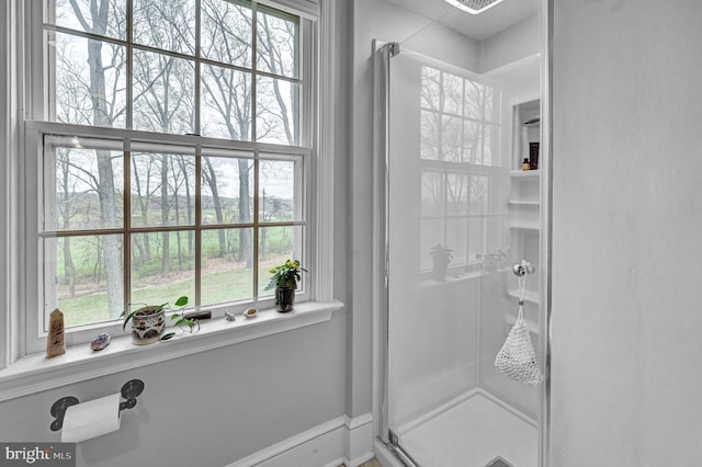 bathroom featuring walk in shower and plenty of natural light