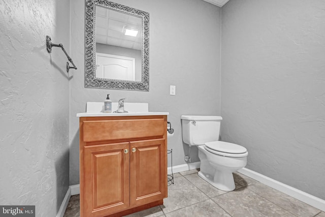 bathroom with vanity, toilet, and tile patterned floors