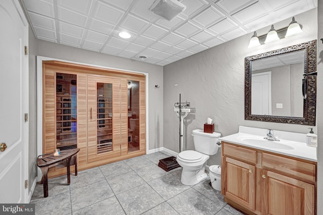 bathroom with toilet, vanity, and tile patterned floors